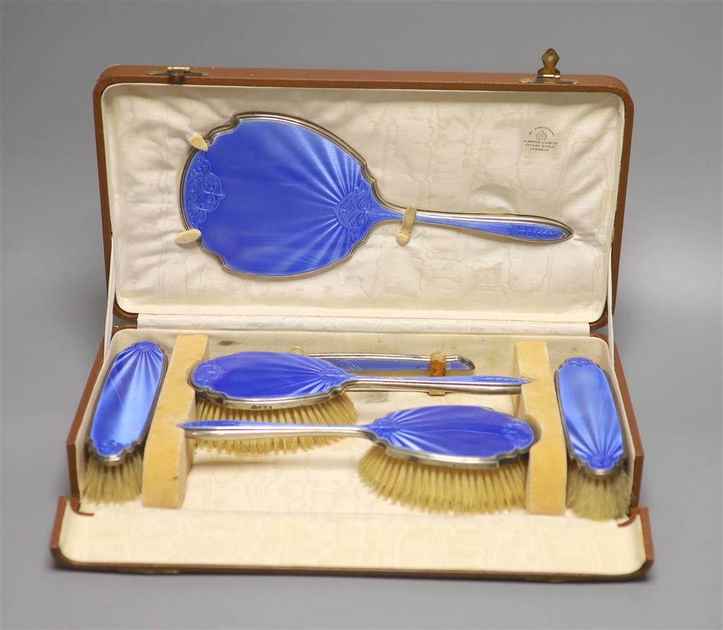 A cased George V silver and blue guilloche enamel six piece dressing set(a.f.) Mappin & Webb, Birmingham, 1929.